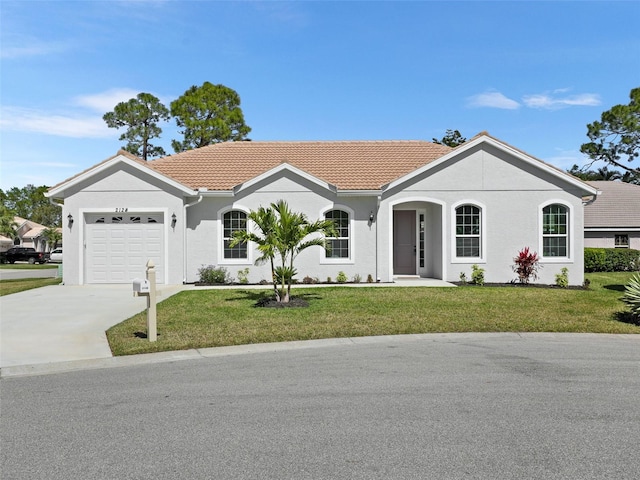 ranch-style home with concrete driveway, a tiled roof, an attached garage, a front yard, and stucco siding