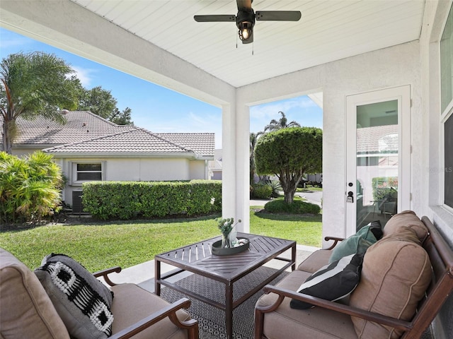 view of patio / terrace with ceiling fan and an outdoor living space