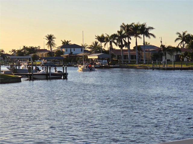 4012 SE 19th Ave Unit 103, Cape Coral, FL 33904 - water view featuring a boat dock, nearby suburban area, and boat lift