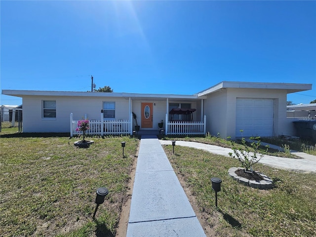 ranch-style home with an attached garage, covered porch, a front lawn, and fence