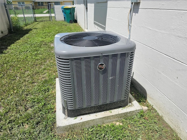 details with a gate, fence, and central AC unit