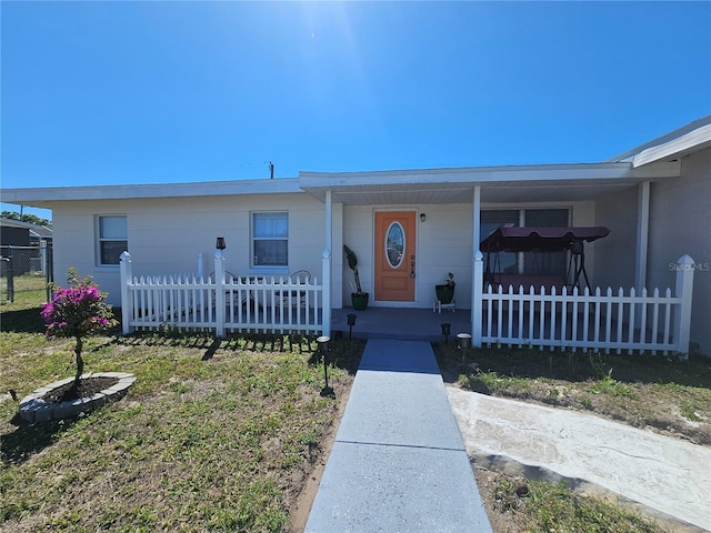 ranch-style house featuring a fenced front yard