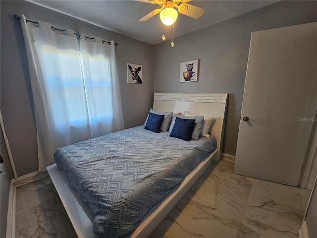 bedroom featuring marble finish floor, baseboards, and a ceiling fan