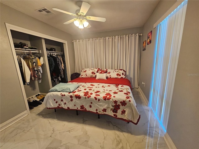 bedroom featuring a closet, visible vents, marble finish floor, and baseboards