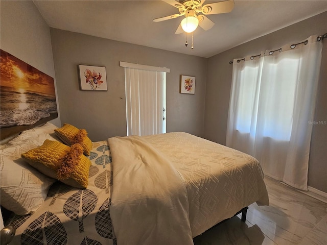 bedroom with marble finish floor and a ceiling fan