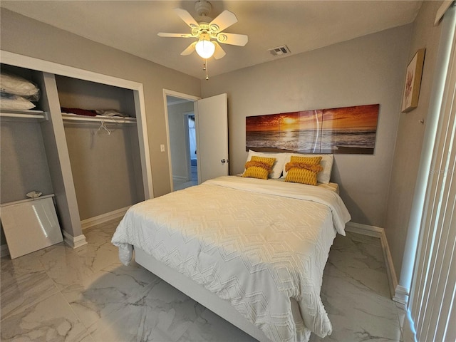 bedroom with marble finish floor, visible vents, and baseboards