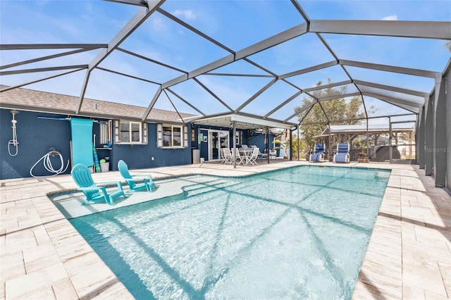 pool with a lanai and a patio area