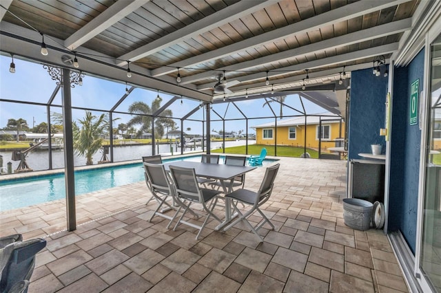 outdoor pool featuring a patio area, a lanai, and a water view