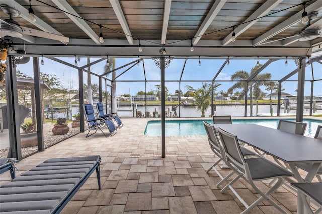 pool featuring ceiling fan, a patio, and glass enclosure