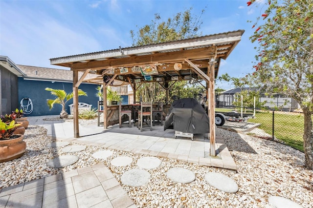 view of patio / terrace with fence, grilling area, and a gazebo