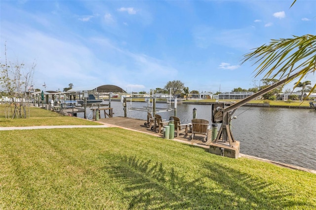 view of dock featuring a water view, a lawn, and boat lift