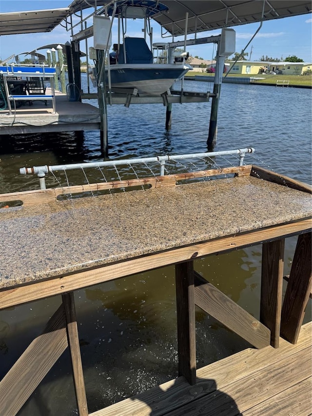 dock area featuring a water view and boat lift