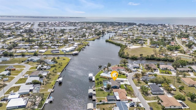 birds eye view of property featuring a water view and a residential view