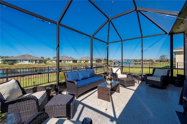 view of patio / terrace featuring glass enclosure, fence, and an outdoor living space