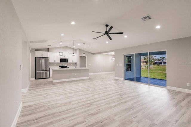 unfurnished living room featuring vaulted ceiling, baseboards, visible vents, and light wood-style floors