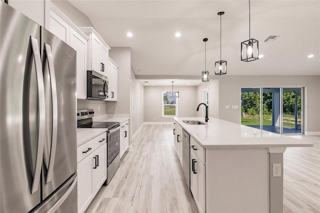 kitchen featuring light countertops, stainless steel appliances, a sink, and recessed lighting