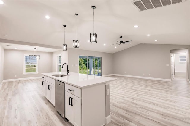 kitchen featuring visible vents, open floor plan, vaulted ceiling, a sink, and dishwasher