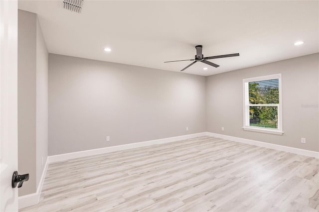 unfurnished room with light wood finished floors, baseboards, visible vents, and recessed lighting