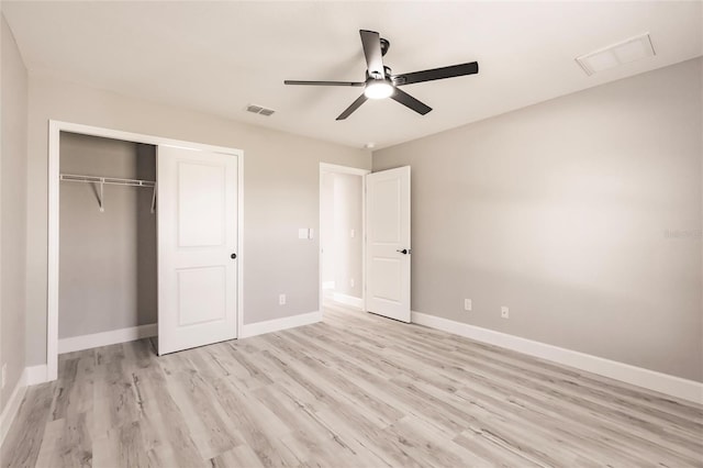 unfurnished bedroom featuring light wood-style floors, a closet, visible vents, and baseboards