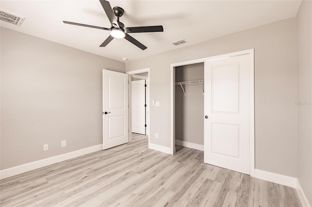 unfurnished bedroom featuring light wood finished floors, a closet, visible vents, and baseboards