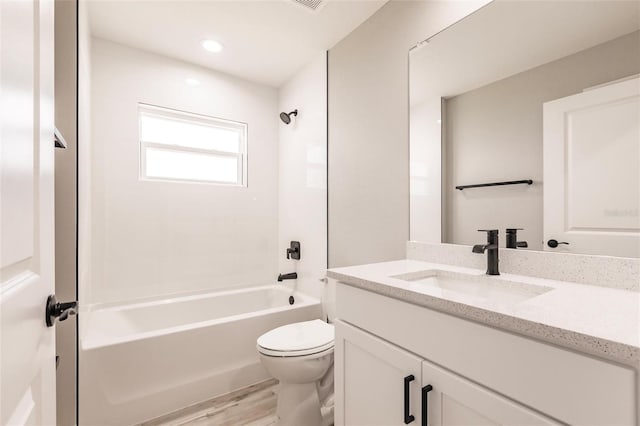 bathroom with  shower combination, wood finished floors, vanity, and toilet