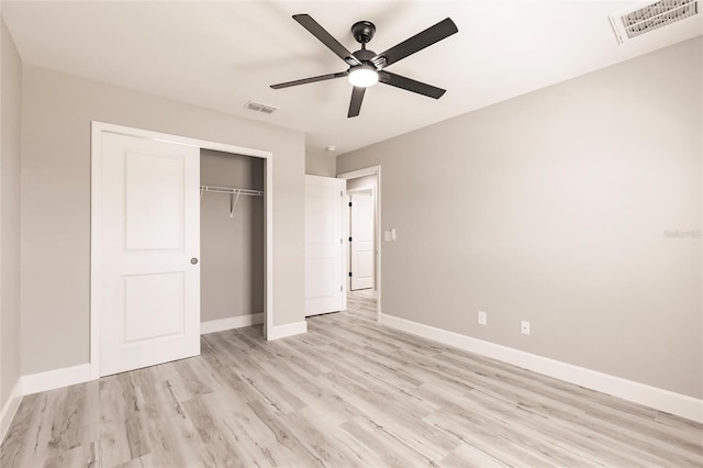 unfurnished bedroom with light wood-type flooring, visible vents, and baseboards