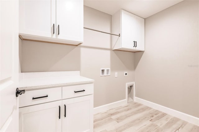 washroom featuring washer hookup, baseboards, cabinet space, light wood finished floors, and electric dryer hookup