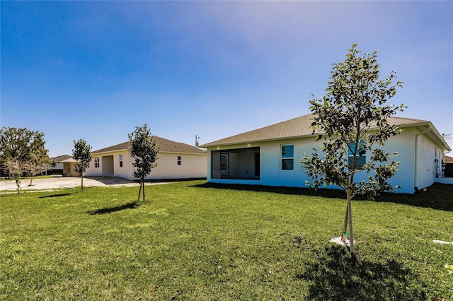 view of front of house featuring a front lawn and stucco siding