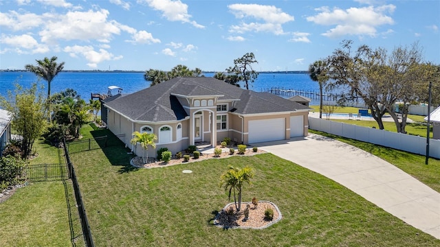 view of front of property featuring fence, an attached garage, stucco siding, a front lawn, and concrete driveway