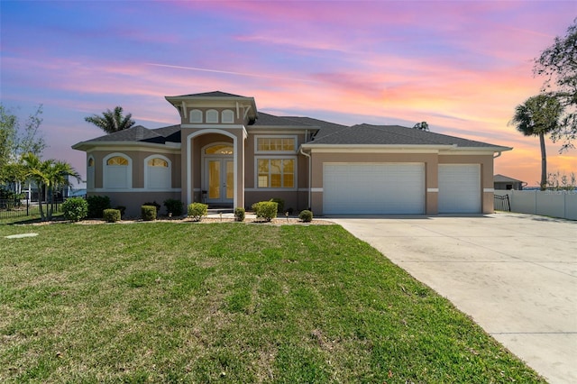 view of front of property featuring fence, stucco siding, concrete driveway, a garage, and a lawn