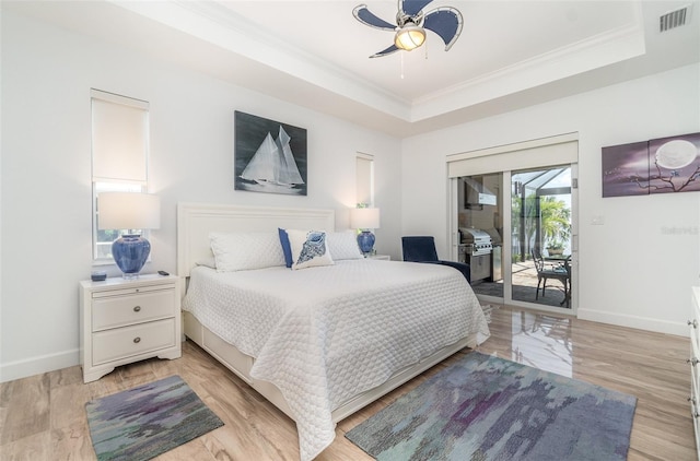 bedroom featuring baseboards, visible vents, ornamental molding, a raised ceiling, and access to outside