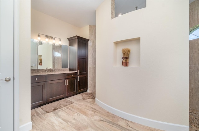 bathroom with vanity and baseboards