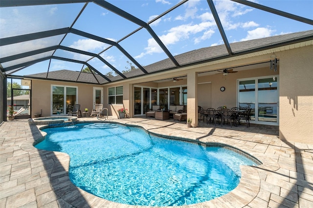 view of swimming pool featuring a ceiling fan, a pool with connected hot tub, outdoor lounge area, a lanai, and a patio area