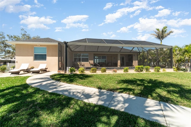 rear view of property featuring a patio, a lanai, a lawn, and stucco siding