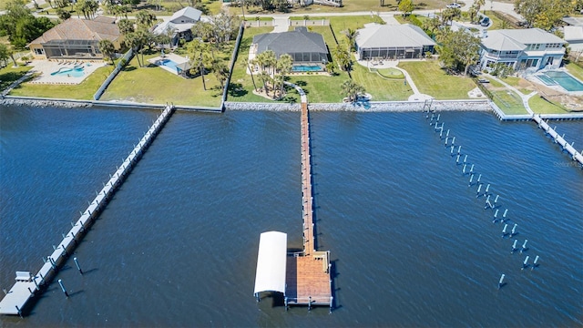 drone / aerial view featuring a residential view and a water view