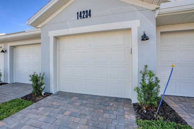 garage with decorative driveway