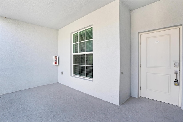 view of exterior entry with stucco siding