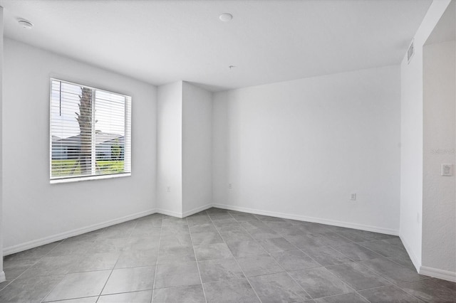 spare room with visible vents and baseboards