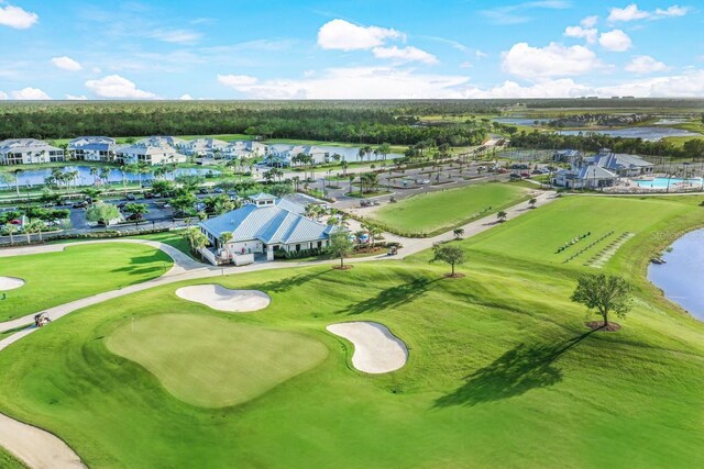 bird's eye view with a water view and view of golf course