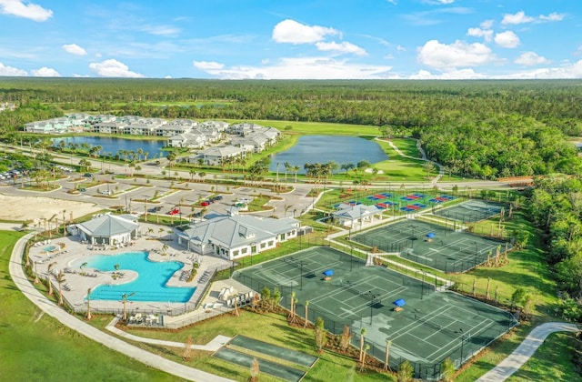 drone / aerial view featuring a water view and a wooded view