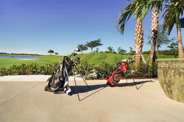 view of play area featuring a yard, a patio area, and a water view