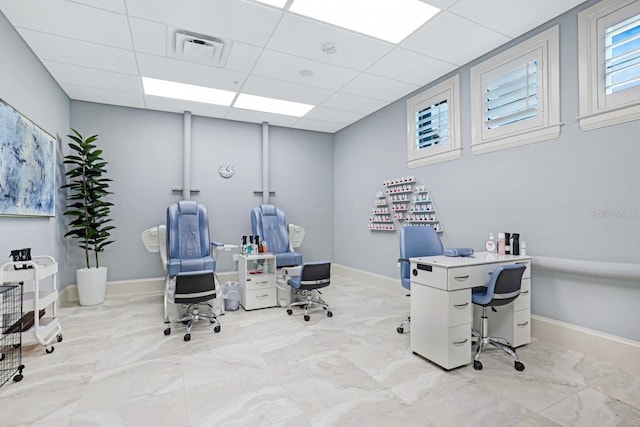 office area featuring a drop ceiling, visible vents, and baseboards