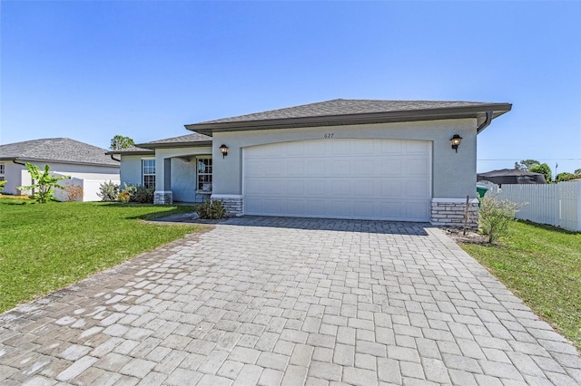 view of front facade featuring decorative driveway, stucco siding, a garage, stone siding, and a front lawn