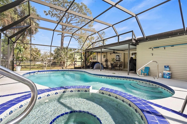 view of pool with a lanai, ceiling fan, a pool with connected hot tub, and a patio