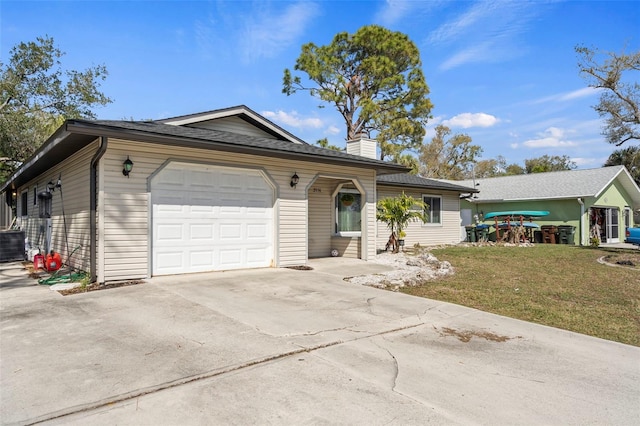 single story home featuring a garage, driveway, a front yard, and a chimney