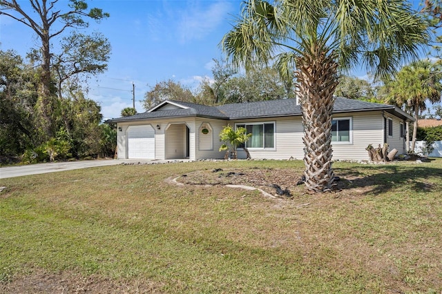 single story home featuring an attached garage, driveway, and a front yard