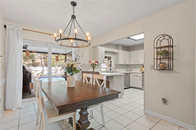 dining space with a notable chandelier, plenty of natural light, and light tile patterned floors