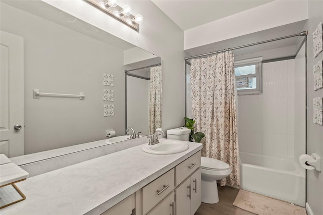 bathroom featuring vanity, toilet, wood finished floors, and shower / bath combo