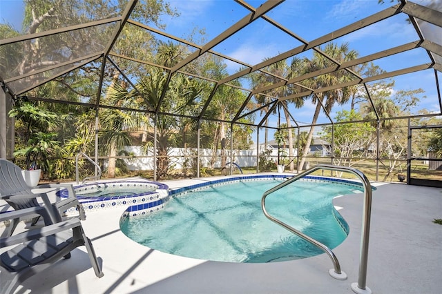 view of pool featuring a patio area, glass enclosure, and a pool with connected hot tub