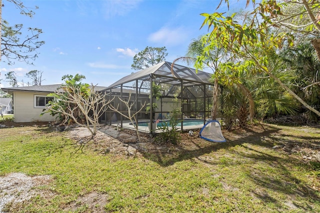 view of yard featuring an outdoor pool and a lanai